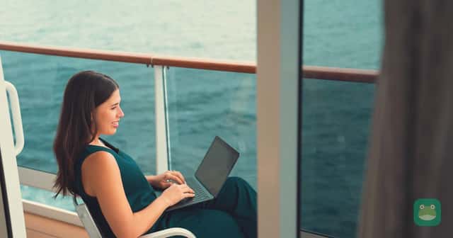 Guest using a laptop on an MSC World America balcony; official MSC internet-package photograph